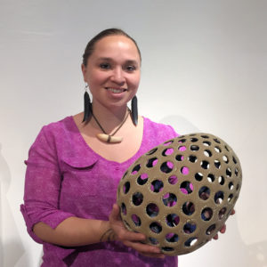 Courtney M. Leonard holding one of her clay pieces from the "Breach" Series, 2016, King Galleries, Scottsdale.